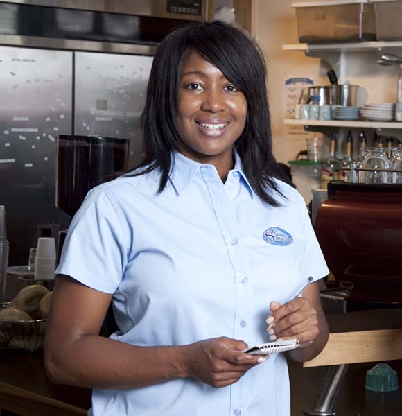 Woman wearing logo shirt at coffee shop