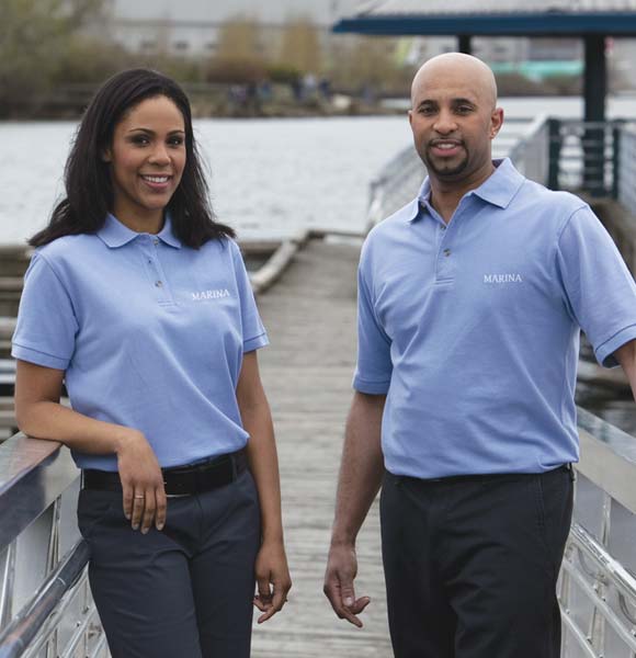 Two staff members standing at marina with logo polos